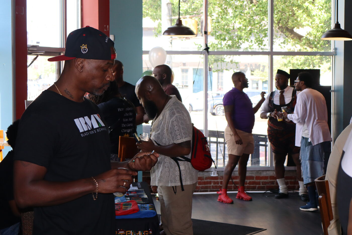 Community members in fellowship at a Black Men's Soul Brunch.